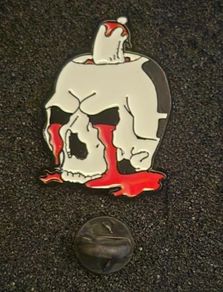 Skull, pin back badge.