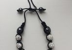 White & black beaded bracelet with diamonds