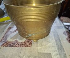 Antique Footed Brass Cachepot Planter features horizontal ribbing near the flared rim and subtle aged patina,