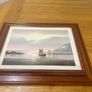 This artwork is a coastal oil painting featuring a traditional single-masted sailing boat stranded or anchored on a calm shoreline, signed by contemporary marine artist David James Image 2