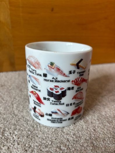 A Mug Featuring Different Types of Sushi