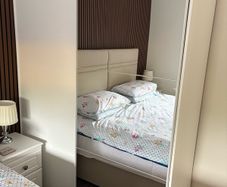 Large white wardrobe with mirrored sliding doors.