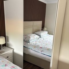 Large white wardrobe with mirrored sliding doors.
