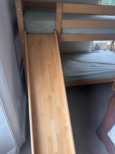 Bunk bed with attached slide and mattresses