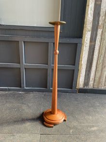 An early 20th century Art Deco oak candle holder with brass top. 122cm