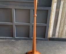 An early 20th century Art Deco oak candle holder with brass top. 122cm