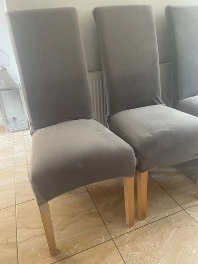 4 dark brown dining room chairs & 4 stretch covers