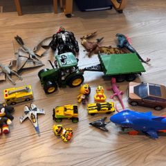 Mixture of toys godzilla, venom, dinosaurus, tracyor