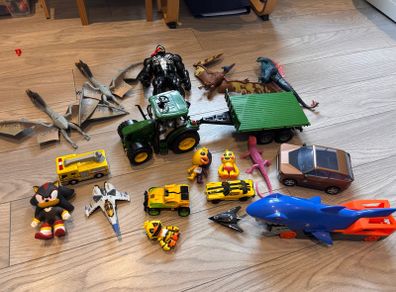 Mixture of toys godzilla, venom, dinosaurus, tracyor