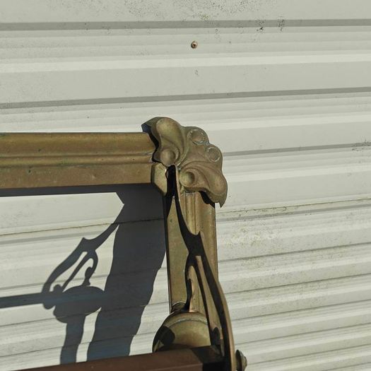 Art Nouveau style cast brass hearth fender with a pair of companion tool holders.