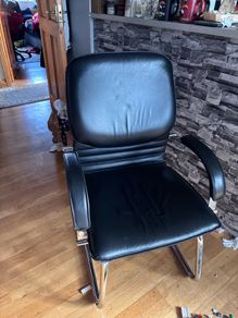 Medium back manager armchair, chrome cantilever frame and fixed padded arms. Black leather