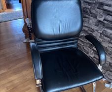 Medium back manager armchair, chrome cantilever frame and fixed padded arms. Black leather
