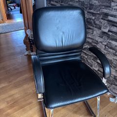 Medium back manager armchair, chrome cantilever frame and fixed padded arms. Black leather