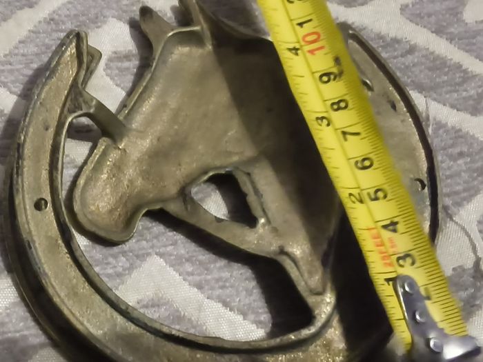 two brass horse shoe door knockers