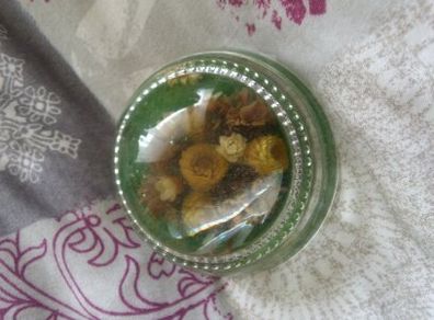nice paper weight with flowers inside glass .