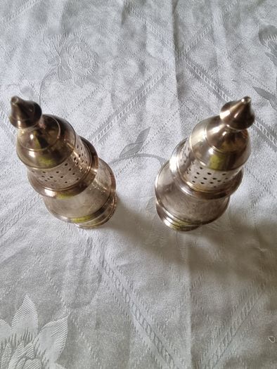 A pair of silver-plated salt shakers