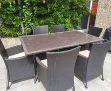 Garden rattan table, 6 chairs and cushions and 2 x Parsol
