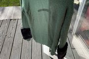 Green jumper with black fur cuffs