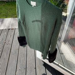 Green jumper with black fur cuffs