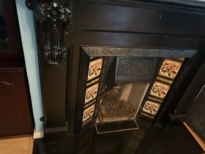 Cast iron fireplace with floral tiles