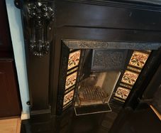 Cast iron fireplace with floral tiles