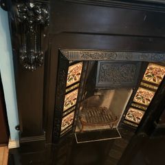 Cast iron fireplace with floral tiles
