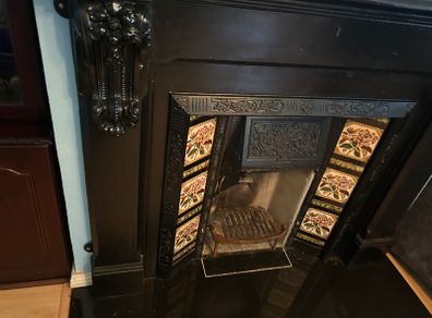 Cast iron fireplace with floral tiles