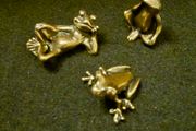 3 brass frogs.