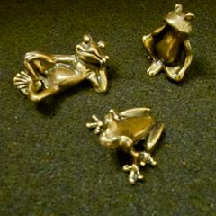 3 brass frogs.