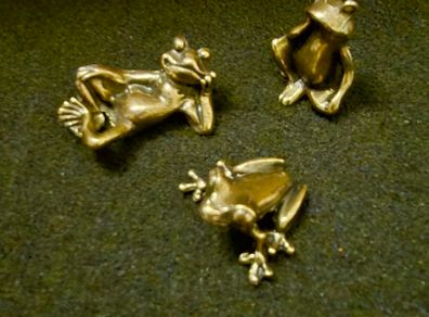3 brass frogs.