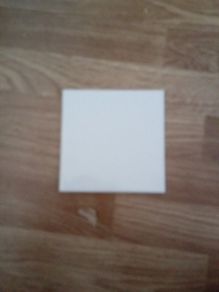 almost full box of white square tiles