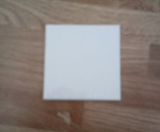 almost full box of white square tiles