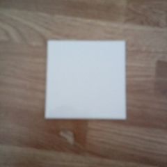 almost full box of white square tiles