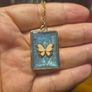 White Butterfly Necklace in Blue Background and Golden Frame Image 3