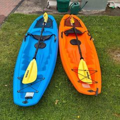 Two Sit on Kayaks