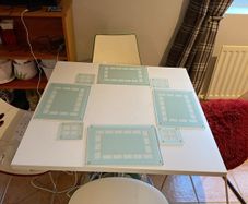 Table mats and matching coasters x 4 in glass