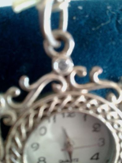 Ladies Quartz Necklace Watch with Filigree Design on Casing and Surrounded by 8 White-Silver Diamante Stones.