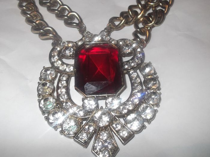 a lovely vintage  costome jewelley pendent with white stones and a large red stone