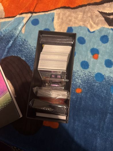 pokemon cards and book and sleeves and game thing