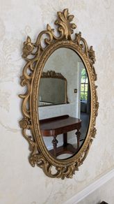 Ornate gold oval wall mirror