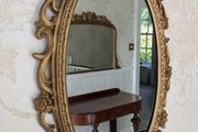 Ornate gold oval wall mirror
