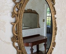 Ornate gold oval wall mirror