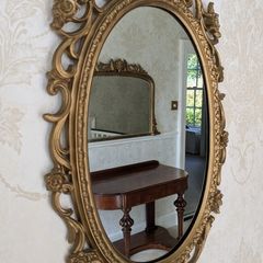 Ornate gold oval wall mirror