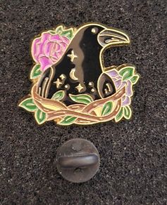 Raven and rose, pin back badge.