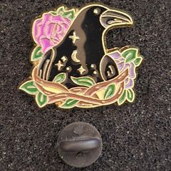 Raven and rose, pin back badge.