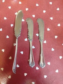 three antique silver-plated flat handle butter spreaders