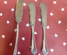 three antique silver-plated flat handle butter spreaders