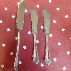 three antique silver-plated flat handle butter spreaders
