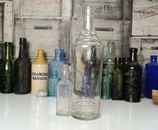 441 - Set of 2 Biggest and Smallest Cork Distillery Company Vintage Collectible Decorative Bottles