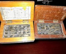 Antique printing equipment in wooden boxes